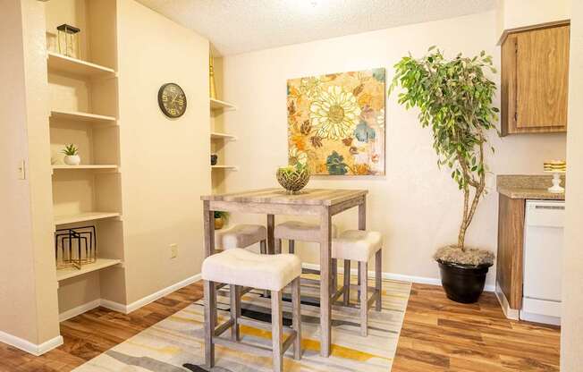 A kitchen with a dining table and chairs.
