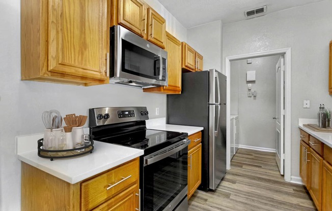 a kitchen with stainless steel appliances and wooden cabinets