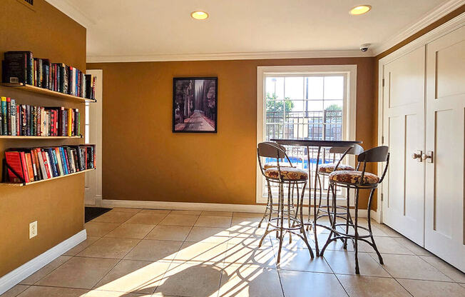 a dining room with a table and chairs and a book shelf