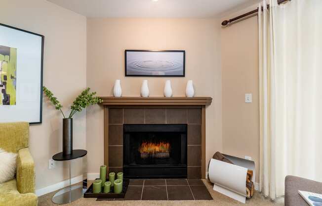 a living room with a fireplace and a painting on the wall