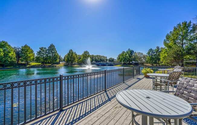 Deck with chairs overlooking the community lake at Cypress Lake at Stonebriar in Frisco, TX!