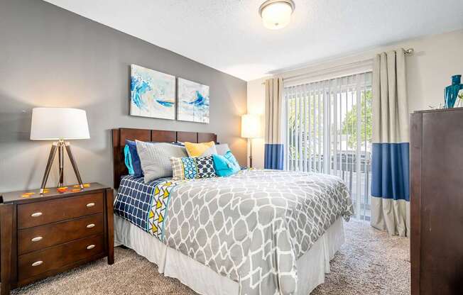 spacious primary bedroom with direct access to private patio or balcony at 701 South Apartments in Mobile, AL