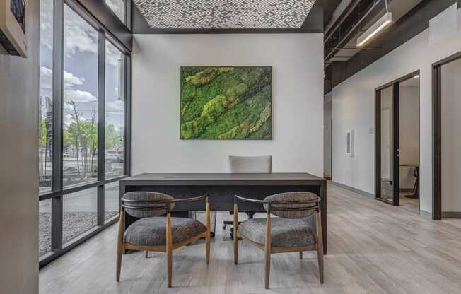 a working table with a table and three chairs