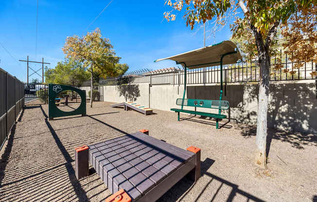 A playground with a slide, swings, and a seesaw.