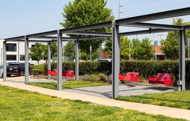 a group of red benches in a park