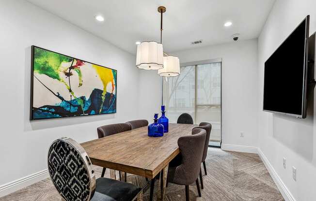 A dining room with a wooden table and chairs.