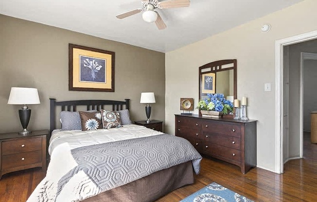 a bedroom with a bed and a ceiling fan