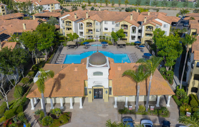An aerial view of a resort with a swimming pool and a gazebo.