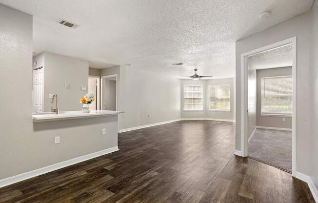 Model living room and entry-area with wood flooring at Hunters Green in Tampa, Florida.