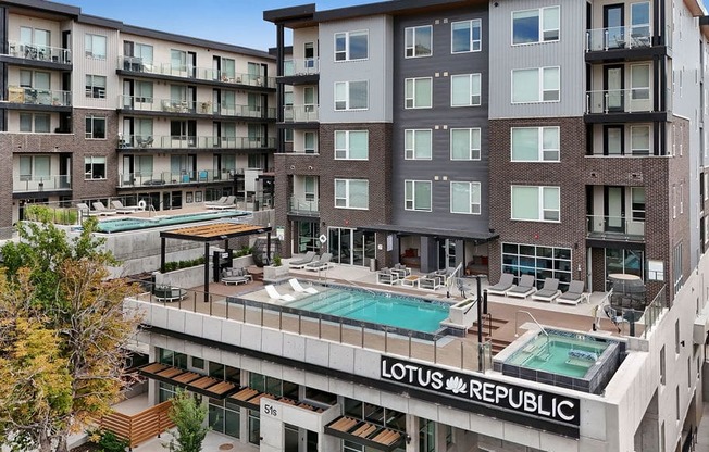 A large apartment complex with a pool and the words