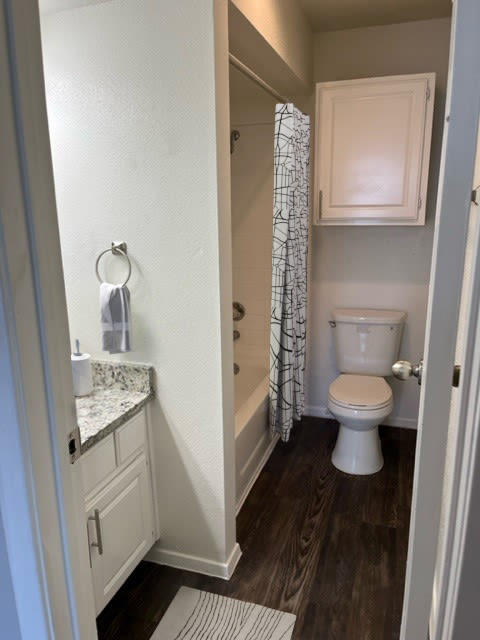 a white toilet sitting in a bathroom next to a shower