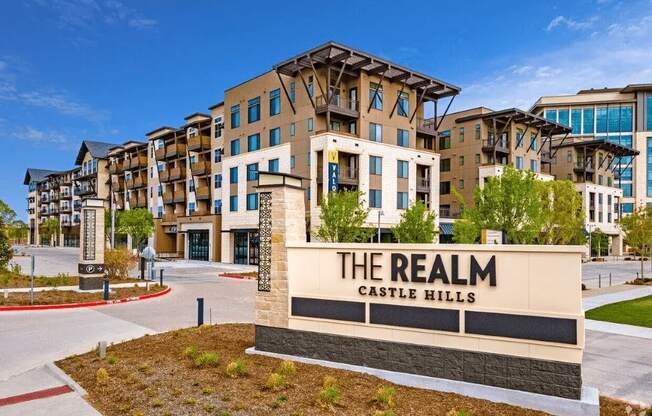 a building with a sign that says the realm casino hills in front of it