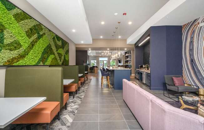 A long hallway with a green wall on the left and a pink wall on the right.