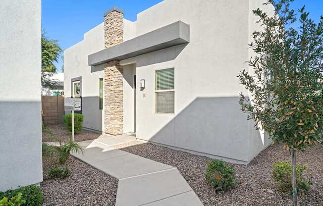 A modern house with a stone pillar entrance.