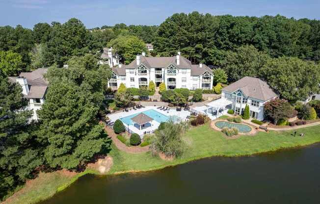 A large white house with a pool in the backyard.