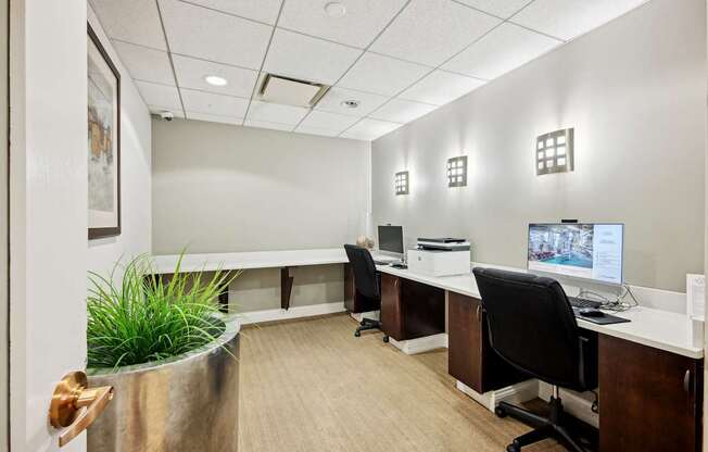 A modern office with a long desk and a computer on it.