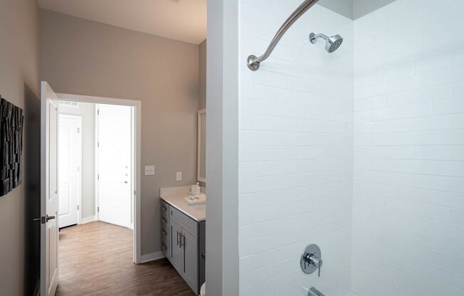 a bathroom with a shower and a sink at One Riverside Apartments, Chattanooga