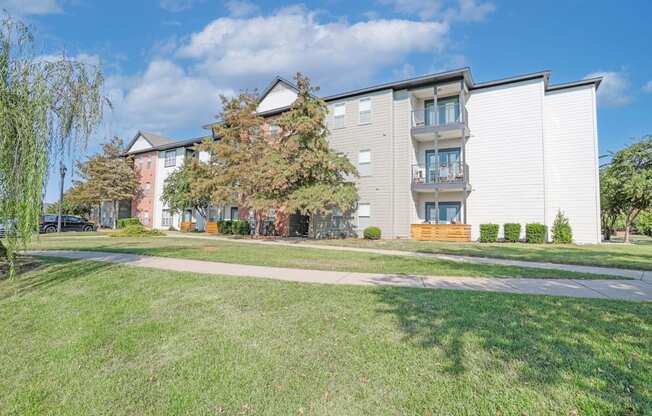 Apartment buildings with green lawns in front.