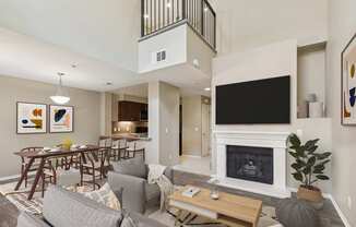 A living room with a grey couch, a wooden coffee table, a fireplace, and a television.