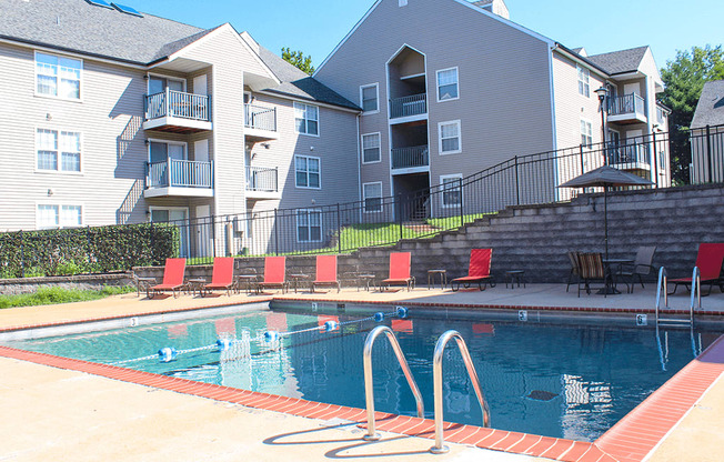 A swimming pool in front of apartment buildings.