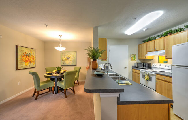 A kitchen with a dining table and chairs.
