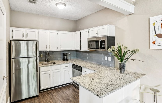 Leasing office kitchen with fridge and microwave at Hunters Chase in Austin, TX