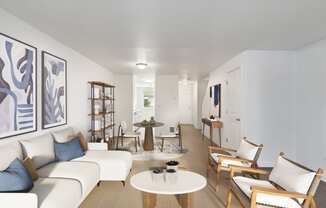 a living room with white couches and chairs and a table