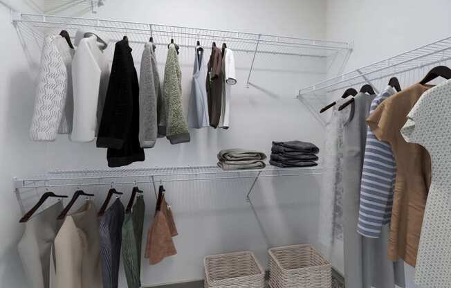a closet with a rack of clothes hanging on the wall