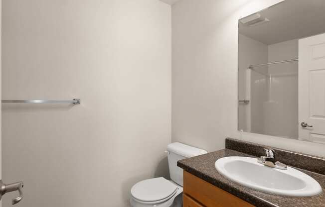 a bathroom with a sink and a toilet and a shower