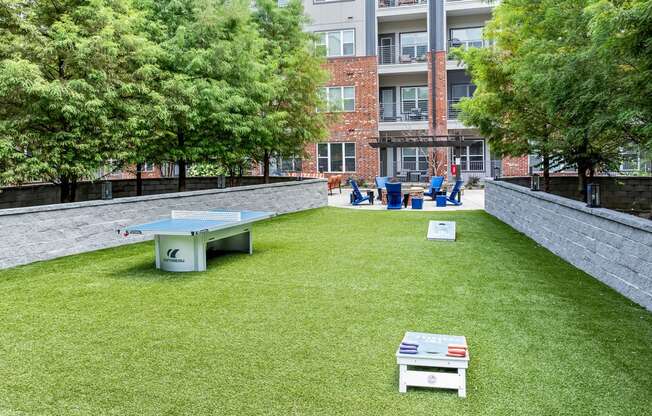 a yard with a ping pong table and benches