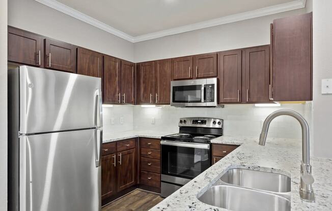 the avenues salt lake custom homes interior kitchen with granite countertops and stainless steel appliances at The Verandah, Austin