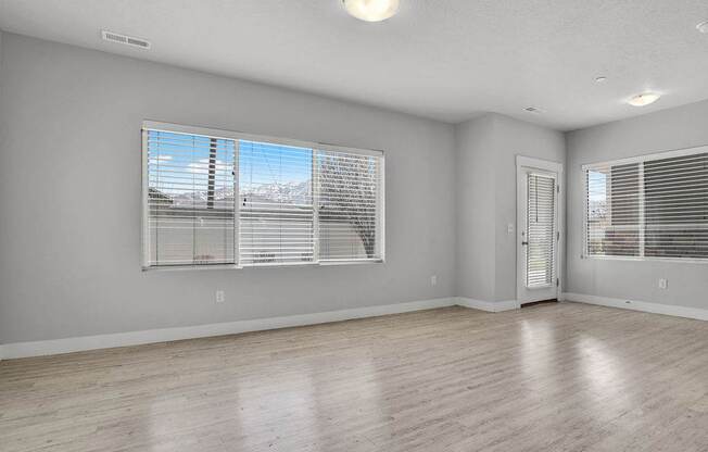 A room with a large window and a door.