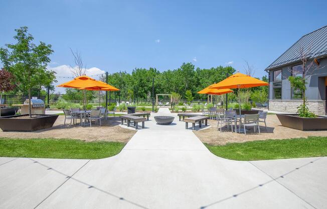 a group of lawn chairs sitting under an umbrella