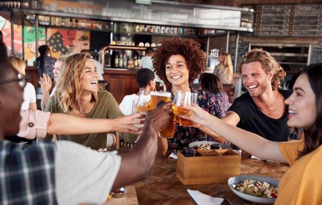 a group of people sitting around a table drinking beer at The Crest at South Point, McDonough Georgia