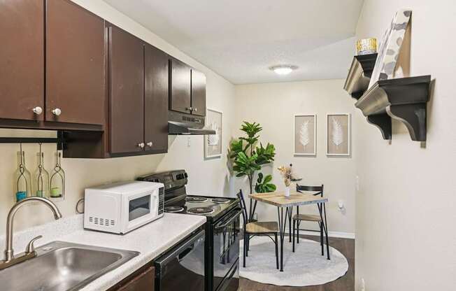 A kitchen with a white microwave on the counter.