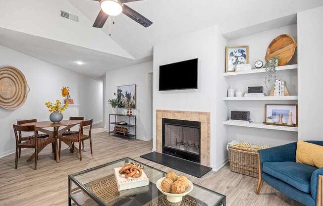 A living room with a fireplace and a flat screen TV at Pointe Royal, Kansas, 66213