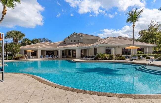 A large house with a pool in front.
