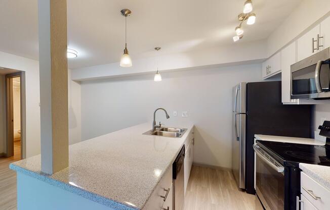 a kitchen with a sink and a mirror