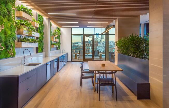 Clubroom with beautiful moss wall with dining areas and gorgeous views of Denver.