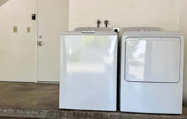 A washer and dryer in a garage.