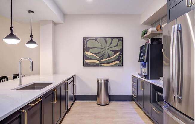 A modern kitchen with a large painting on the wall.