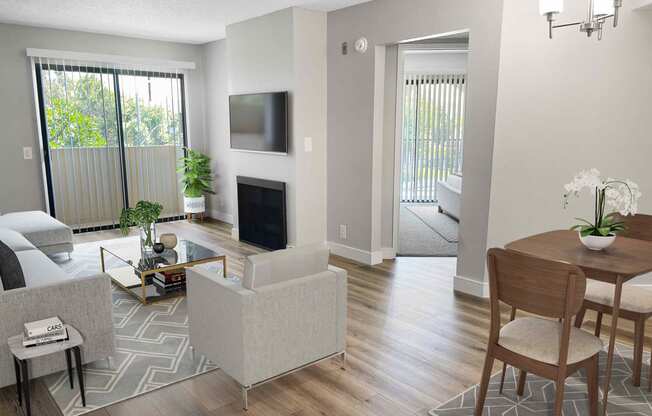 a living room with a fireplace and a table and chairs