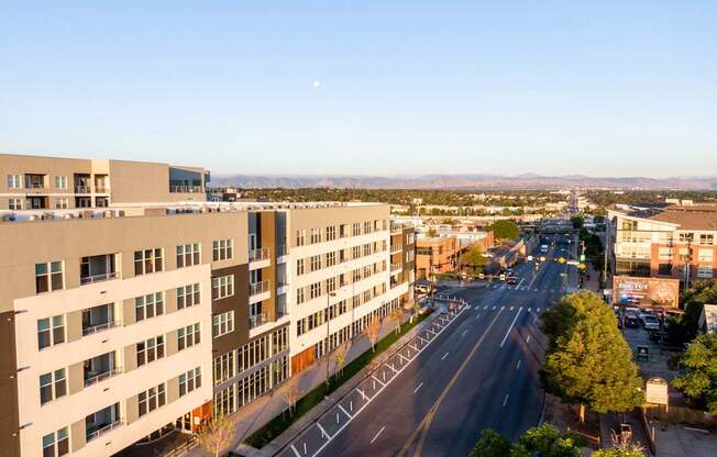 A large building is on the left and a road is in the middle of the image.