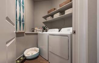 A small laundry room with a washer and dryer.