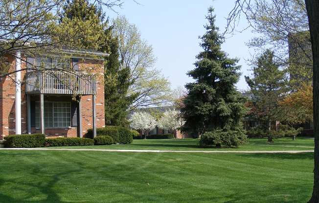 a lawn in front of a brick building