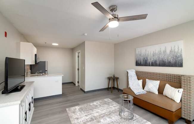 a living room with a couch and a ceiling fan