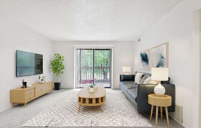 A living room with a couch, a wooden coffee table, and a flat-screen TV mounted on the wall at Old Monterey Apartments in Springfield, MO