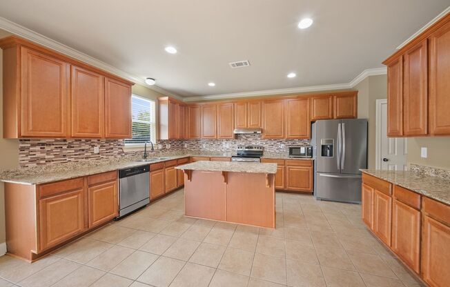 3 Bedroom home with a Bonus area! Sits on a Lake with a fenced yard!