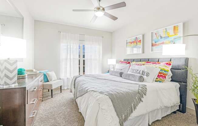 a bedroom with a large bed and a ceiling fan