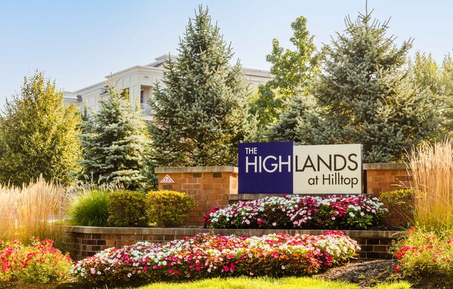 The Highlands at Hilltop sign in front of a building.
